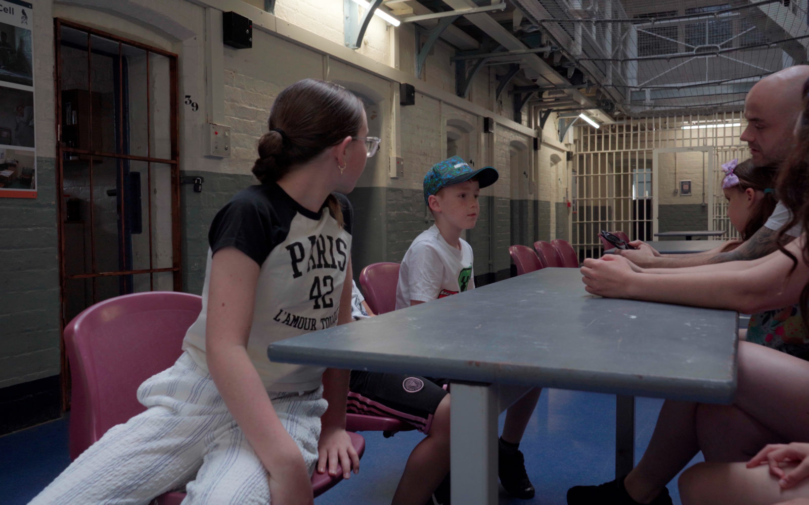 Family sat in discussion on prison wing